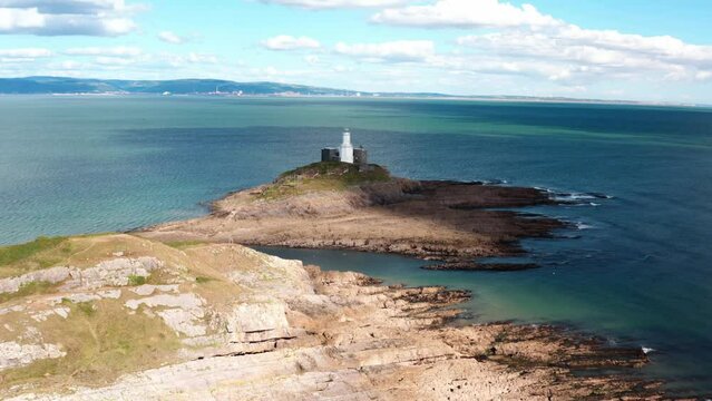 Aerial view of Bracelet Bay the Gower Peninsula South Wales with Mumbles lighthouse, Swansea city,