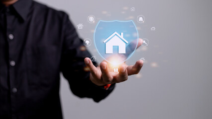 House or Family Insurance Concept. Company Supporting and Protecting their Customer by Shield, Home Icon floating over a Careful Gesture Hand of a Businessman