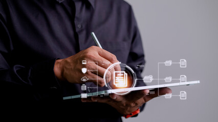 Businessman using a tablet to document management concept, online documentation database and digital file storage system or software, records keeping, database technology, file access, doc sharing.