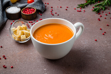Soup cream of tomato on brown table