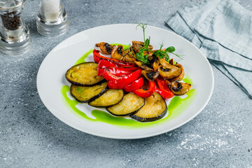 grilled vegetables on a plate on grey table