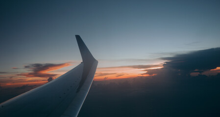 Obraz premium view from airplane window on the wing on sunset time.