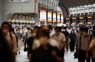 Japanese businessmen and women are commuting while wearing masks during covid-19