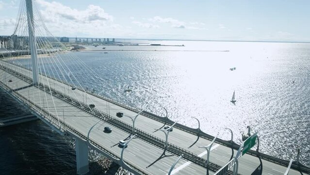 Saint Petersburg, Russia - 06.08.2022: Aerial view of the Cable-stayed Bridge and the ZSD Highway next to the buildings on the banks of the Neva with ships and yachts