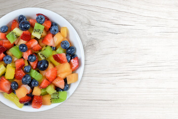 Fresh Cut Fruit Salad on White Wood Background with Copy Space