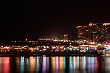 Fototapeta na wymiar city skyline at night sea reflections