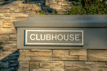 La Jolla, California- Clubhouse label on a wall outside with stones
