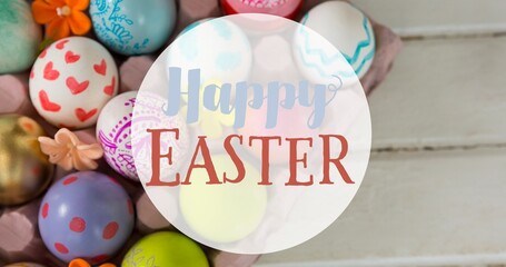 Overhead view of happy easter text over multi colored eggs on table