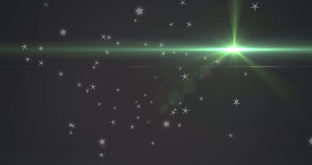 Naklejka premium Image of glowing green light moving over stars in background