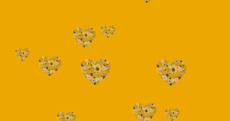Image of flower hearts moving in hypnotic motion with copy space on orange background