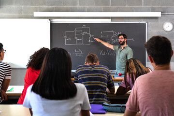 Male caucasian teacher explaining electronics and physics to multiracial high school students. - obrazy, fototapety, plakaty
