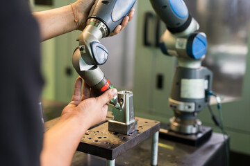 Worker use robot CNC lathe machine to metal hardware