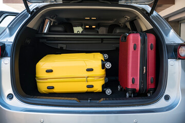 Trunk of suv car loaded with travel luggage or baggage - obrazy, fototapety, plakaty