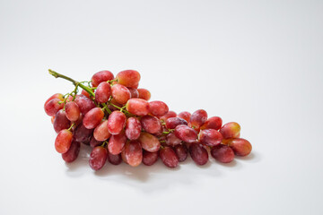1 bunch of red ripe grapes on a white background