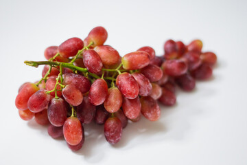 1 bunch of red ripe grapes on a white background