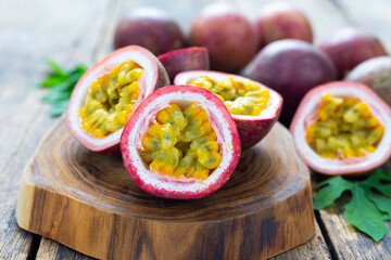 Passion fruit ( Maracuya ) with Passion fruit cut in half slice on wooden table background .