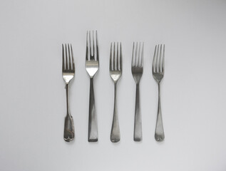 A variety of vintage forks on white background. Top view.