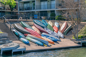 Austin, Texas- Upside down colorful canoes on a concrete dock at Colorado River