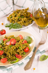 Fusilli pasta with cherry tomatoes and peas.
