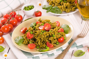 Fusilli pasta with cherry tomatoes and peas.