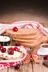 Rye bread with cottage cheese and cherries.