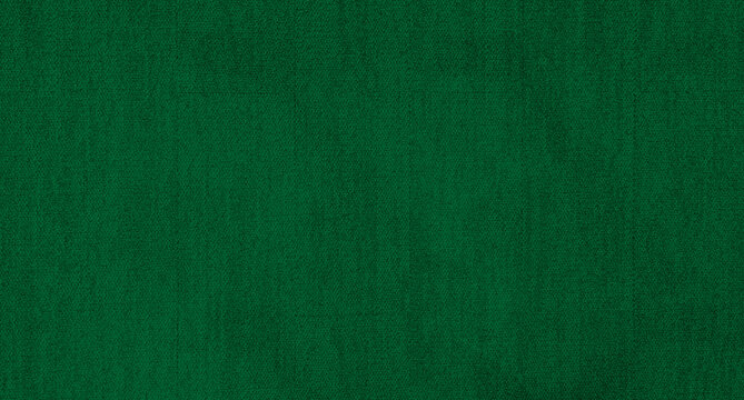 green carpet background texture, shot from above. texture tight weave carpet. elegant dark green color background of the carpet.
