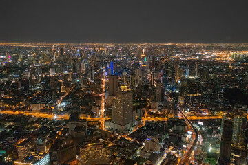 Fototapeta premium Aerial view of highway street road at Bangkok Downtown Skyline, Thailand. Financial district and business centers in smart urban city in Asia. Skyscraper and high-rise buildings at night.