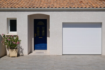 modern house facade with contemporary white garage roll gate door