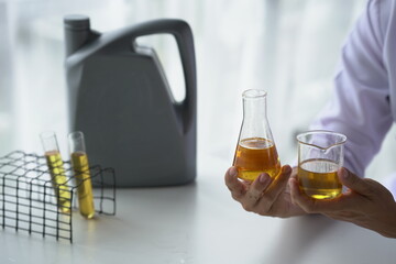 Oil pouring, Equipment and science experiments, Formulating the chemical for medicine, Organic pharmaceutical, Alternative medicine concept. (Selective Focus)