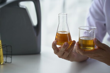 Oil pouring, Equipment and science experiments, Formulating the chemical for medicine, Organic pharmaceutical, Alternative medicine concept. (Selective Focus)
