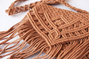 Handmade macrame cotton сross-body bag. Eco bag for women from cotton rope. Scandinavian style bag.  Brown color, sustainable fashion accessories. Details. Close up image