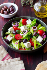 Greek salad with feta cheese, tomatoes, cucumbers, peppers and Kalamata olives. Healthy eating. Vegetarian food.