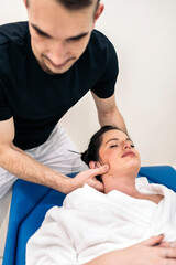 Fototapeta na wymiar Physiotherapist Massaging Woman's Neck