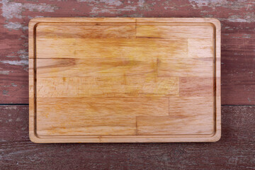 Empty kitchen board on a wooden background. Cutting board. Space for text.