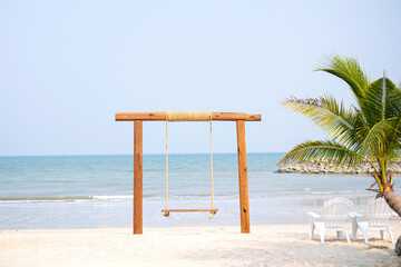 One swing is placed by the sea during the day, giving a relaxing holiday feeling.