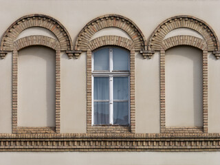 Front view of a vintage-style window on a brown facade