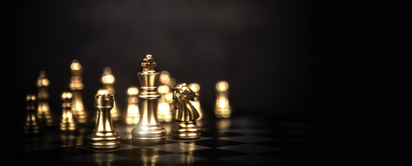 King chess stand on chessboard concept of challenge or team player or business team and leadership strategy or strategic planning and human resources organization risk management. © Jintana