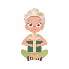 A happy girl sits in a lotus position and holds a gift box in her hands.