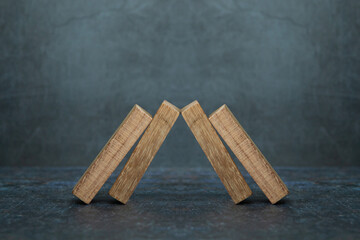 Wooden block stacked pyramid concept of prevent collapse or crash of financial business and risk...