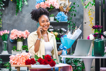 African American womanlogger influencer or SME owner people smile work on home video camera selfie shoot.Smiling female florist talking on mobile phone. Young woman working at flower shop.