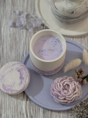 Soy candle in a concrete, plaster candlestick, decor interior. Home decoration with a burning scented candle. Spa. Natural.