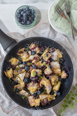Kaiserschmarrn - traditional austrian pancake dessert with blueberries on a table