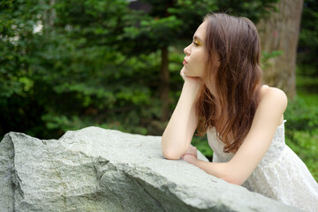 City portrait of beautiful young woman in white dress.