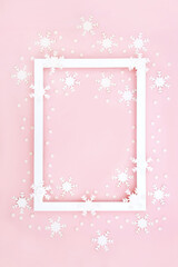 Christmas winter New Year background border on pastel pink with white snowflake decorations. Abstract festive design for greetings card, label, gift tag, menu or invitation.