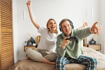 A young family has fun playing computer games.The concept of relaxing at home, entertainment