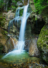 Beautiful little waterfall with rocks and moss. Allgau, Bavaria, Germany