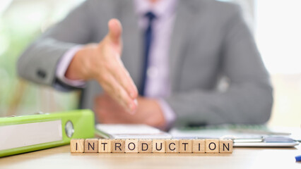 Businessman pulls his hand forward for handshake closeup