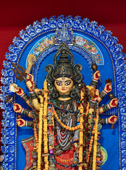 Closeup of Hindu Goddess Durga inside a pandal (temporary resting place for idol) during Durga puja festival in Kolkata. In 2021 It has been declared UNESCO's Intangible Cultural Heritage of Humanity.