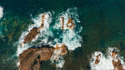 drone shot of rocks in the ocean