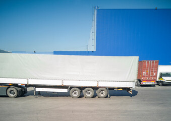 View of large trucks near the logistics warehouse. Logistics, transportation, trade